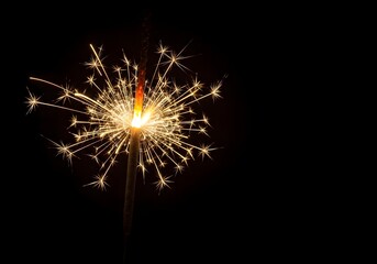 Fototapeta premium Festive Glowing Sparkler Celebration Light and Joyful Firework Holiday Spirit Brightness in the Darkness Magical Display for New Year's Eve Party Fun Sparkling Surprise