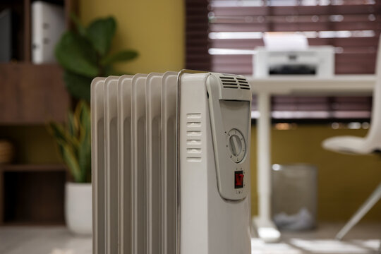 Modern portable electric heater in room, closeup