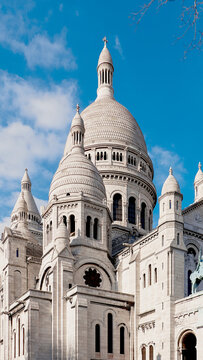 Sacre-Coeur Basilica in Montmartre framed by blue sky and gentle spring light