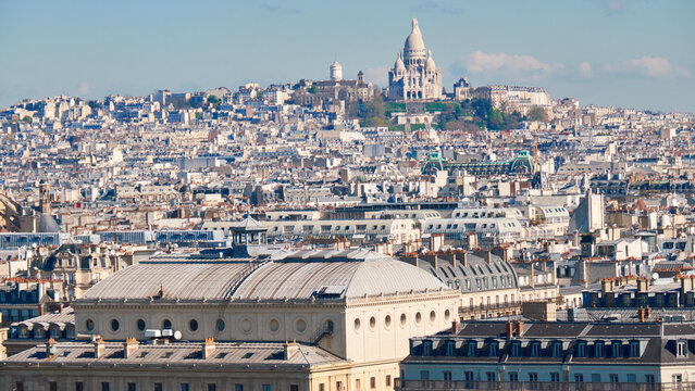 Sacr&eacute;-C&oelig;ur Basilica overlooks Paris rooftops in soft spring morning light