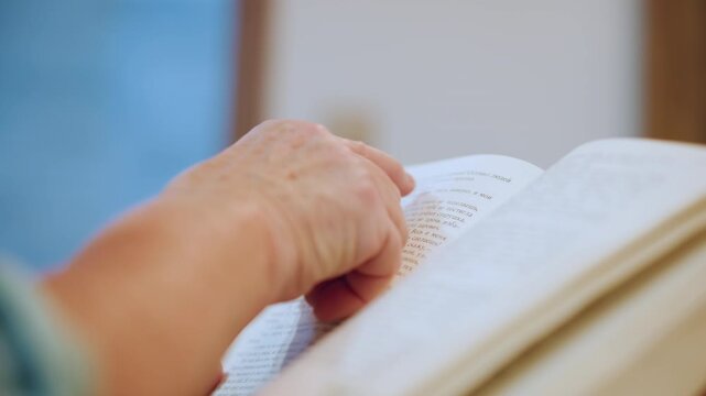 Closeup grandma finger tracing braille. Elderly hand reads tactile dots in sunlit room, slow deliberate movement, warm atmosphere, quiet morning, intimate learning moment with implied grandson
