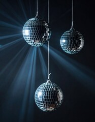 Three sparkling disco balls suspended against a dark background, reflecting light beams and creating an energetic atmosphere.