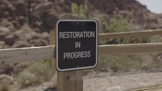 Restoration in Progress sign on fenced area 4k