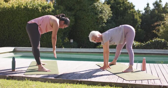 Diverse senior female teacher with student after cue, folding on pool deck beside two bottles