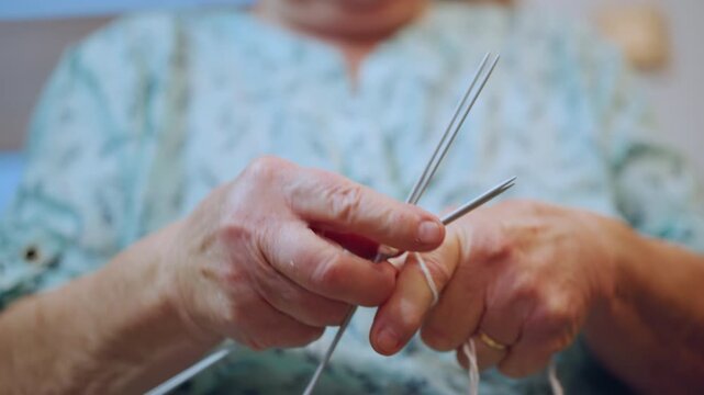 Elderly woman lovingly constructs quilt to support community welfare projects. Respectful grandmother diligently assembles patchwork quilt to aid charitable initiatives in community