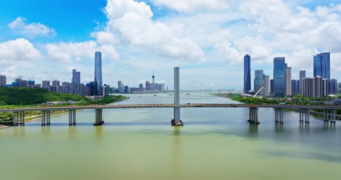 Aerial view of a cable-stayed bridge spanning a river and connecting city districts in Zhuhai, China