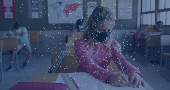 Vertical video: Writing after sheet cue, masked kid in pink top in class using green pencil overlay