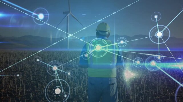 Male tech walking to wind turbine while HUD appearing, sparking network growth for wind farm ops
