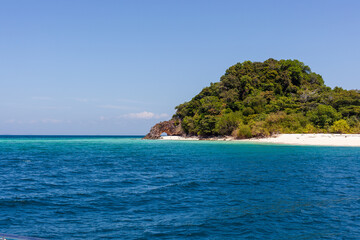 Fototapeta premium Ko Chuku Islet in Tarutao National Marine Park. Tropical green island with clear blue waters.
