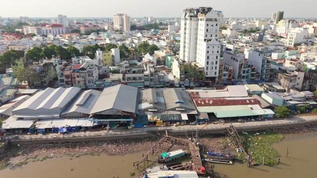 Can Tho Dockside Warehouses Heavy Equipment Loading Cargo, Aerial Panorama Of Cranes, Freight Boats And Loaders, Workers Coordinating Logistics, Storage Roofs Lining Riverbank, Industrial