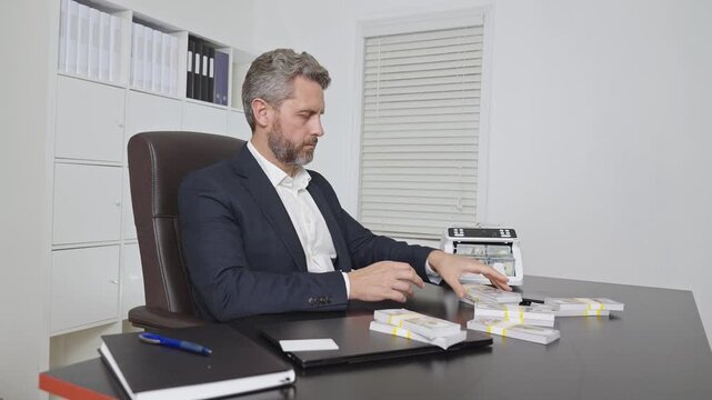Businessman in suit at office desk with money counting machine. Finance expert. Banker money counting in office. Financial control. Money operation in bank office. Business man in money counting