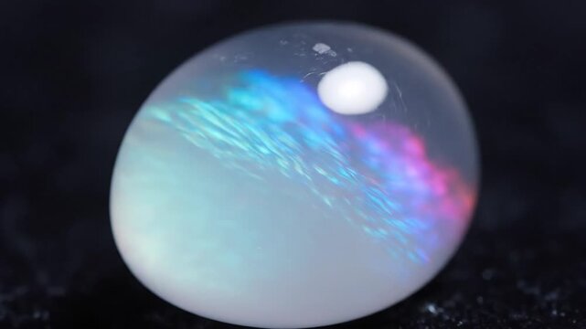 Opalite Gemstone Displaying Iridescent Light Against Black Background