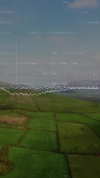Vertical video: Aerial agriculture showing waveform visualizing sound, rising into sky above ridge