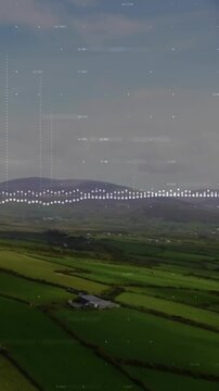 Vertical video: Camera descending showing barn fields, waveform and bars pulsing for farm insights