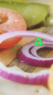 Vertical video: Camera panning, patty entering, onion ring visible, eco icons over food ads