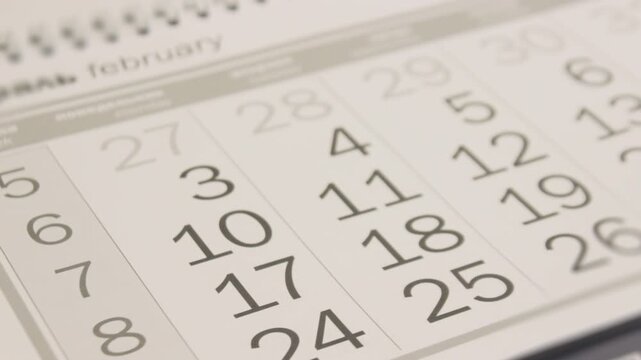 Business Calendar With Pages Flipping Through Dates. Close Up View Of Monthly Planner Showing Meeting Schedule Important Days And Corporate Events Organization Time Management