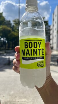 Body Mainte conditioning drink by Otsuka Pharmaceutical held by a person outdoors featuring plant-based lactic acid bacteria B240 nutritional label - Tokyo, Japan, September 24, 2023