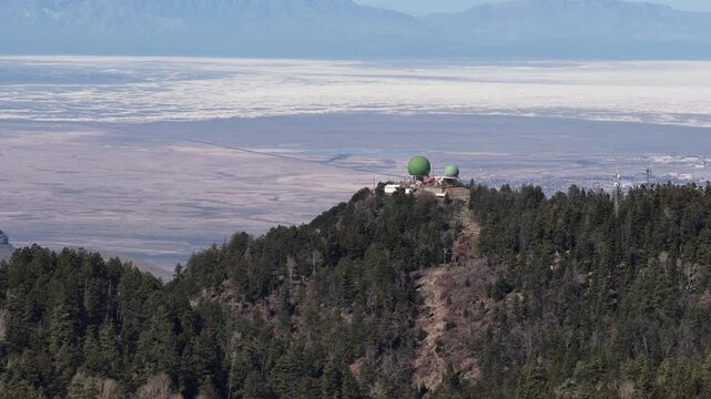 Aerial of Alamo Peak observatory in Lincoln National Forest Cloudcroft New Mexico with White Sand backdrop