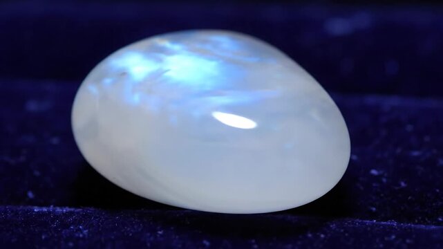 Smooth moonstone gemstone with adularescence glowing softly