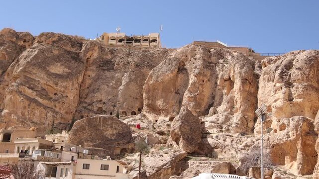 Exterior view of the Monastery in Ma'aloula, Syria, built into the massive rocky limestone cliffs. Famous Christian pilgrimage site in the mountains near Damascus