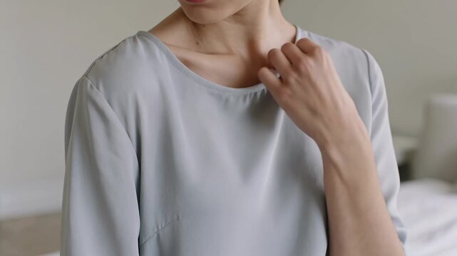 A woman experiencing shoulder pain while working out in a modern gym during a fitness session