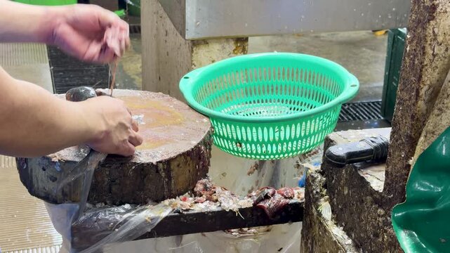Filipino Fish Vendor Cleaning Milkfish and Waving at Quinta Market Manila