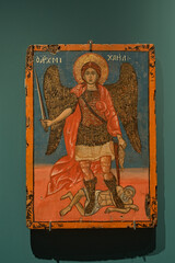 Fototapeta premium Archangel Michael icon in Orthodox Christian style, antique religious painting displayed indoors