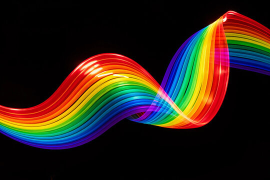 Vibrant rainbow arcs against deep black background.