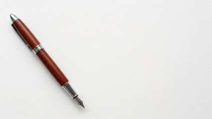 Fototapeta premium Wooden fountain pen on white paper