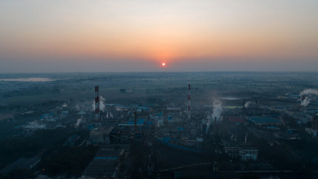 cement factory sunrise, industrial pollution aerial, smokestacks sunrise, factory emissions view, industrial skyline sunrise, cement plant aerial, pollution industry view, factory smoke landscape, ind