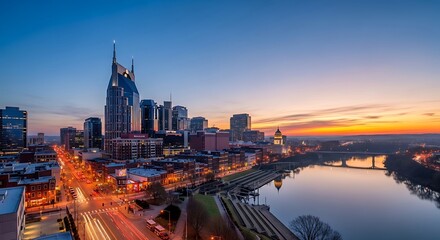 Fototapeta premium City skyline at sunrise with river and dramatic sky
