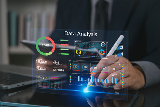 Businessman using tablet and stylus with virtual data analysis dashboard hologram. Concept of business intelligence, big data analytics, global financial statistics and corporate performance report.