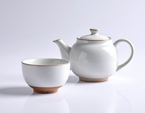 Minimalist white ceramic teapot and matching teacup set, featuring warm natural brown bases, elegantly presented on a bright reflective surface for a tranquil tea ritual