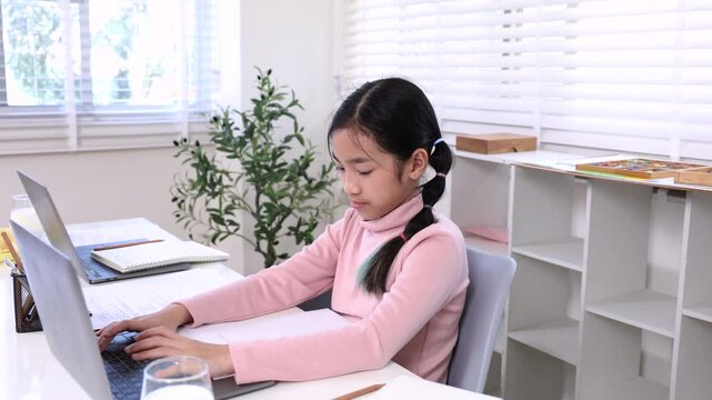 Education learning children home technology concept shows child typing on laptop while classmate writes notes, modern remote study, alpha elementary generation schoolgirl lifestyle doing homework