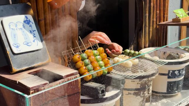 Traditional Japanese Dango Mochi Skewers Grilling Over Charcoal in Kyoto