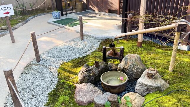 Traditional Japanese Shishiodoshi Bamboo Water Fountain in Zen Garden