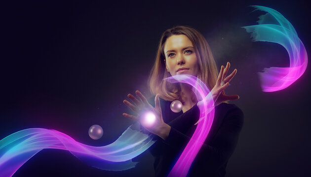 Woman conjures glowing orbs with swirling purple and blue lights in dark studio.