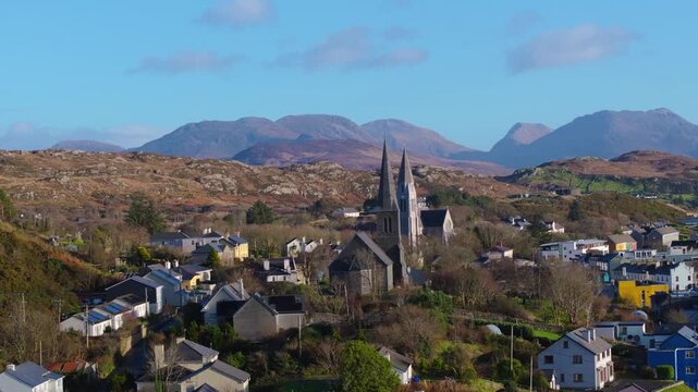 4K Aerial drone footage of St Joseph&rsquo;s Church and Christ Church Clifden with Connemara Mountains Background_014