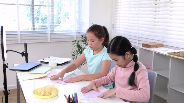 Children online learning content creator, elementary girls explain homework to teacher record creative activity and phone, digital education, creativity vlog, modern alpha generation study lifestyle