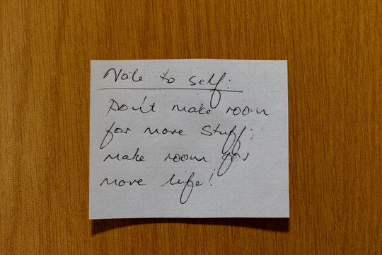 Motivational note to self stuck to a wood surface referring to improving your life