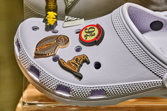 Ambato, Ecuador - June 09, 2025: Crocs footwear display featuring unique charms in a vibrant shopping center, showcasing creativity and personalization in fashion accessories