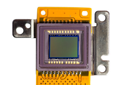 The light sensor panel of a digital camera, with its electrical circuit board, metal, and connectors, is separated on a white background.