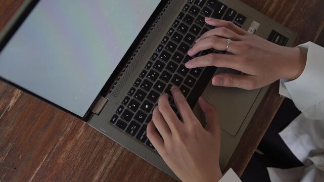 Close-up of a woman's hands typing on a laptop. The concept of working anywhere, working remotely.