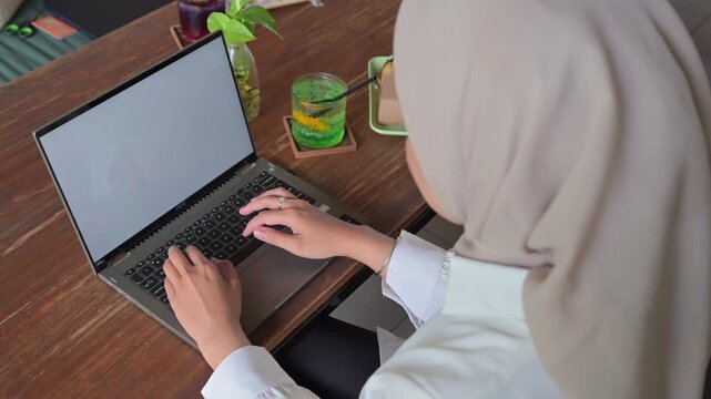 Close-up of a woman's hands typing on a laptop. The concept of working anywhere, working remotely.