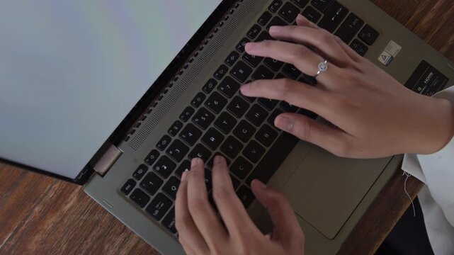 Close-up of a woman's hands typing on a laptop. The concept of working anywhere, working remotely.