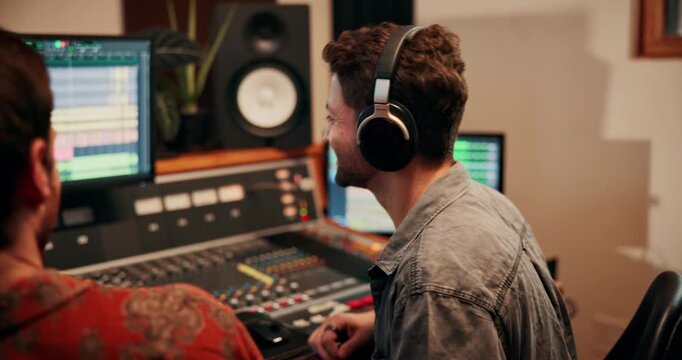 Production, talking and producers with headphones for music in studio working on album or song. DJ, equipment and male sound technicians with computer for mixing audio track in recording booth.