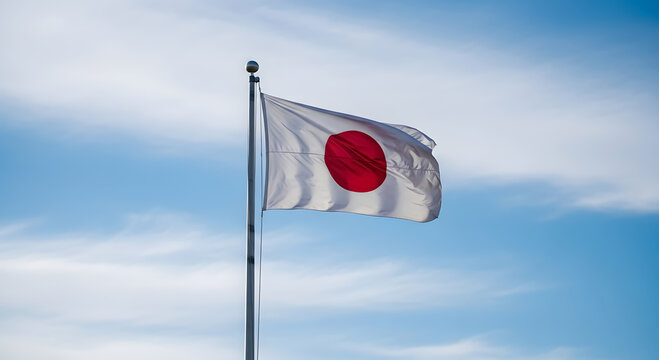 The japanese flag waving proudly against a clear sky backdrop