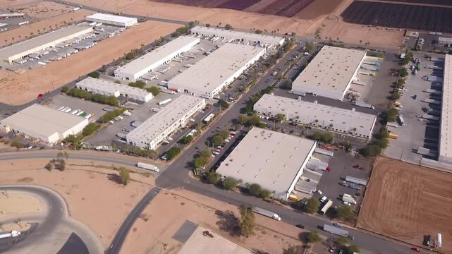 Drone aerial of industrial warehouses along the Calexico&ndash;Mexicali border, showcasing logistics operations and large-scale infrastructure.