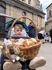 Baby in stroller with wicker basket decoration in city square Easter Ukraine Lviv Vyshyvanka © phpetrunina14
