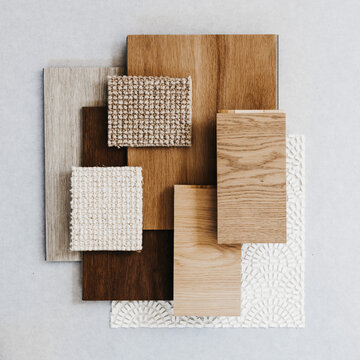 Neutral interior design material samples wood fabric and tile flat lay